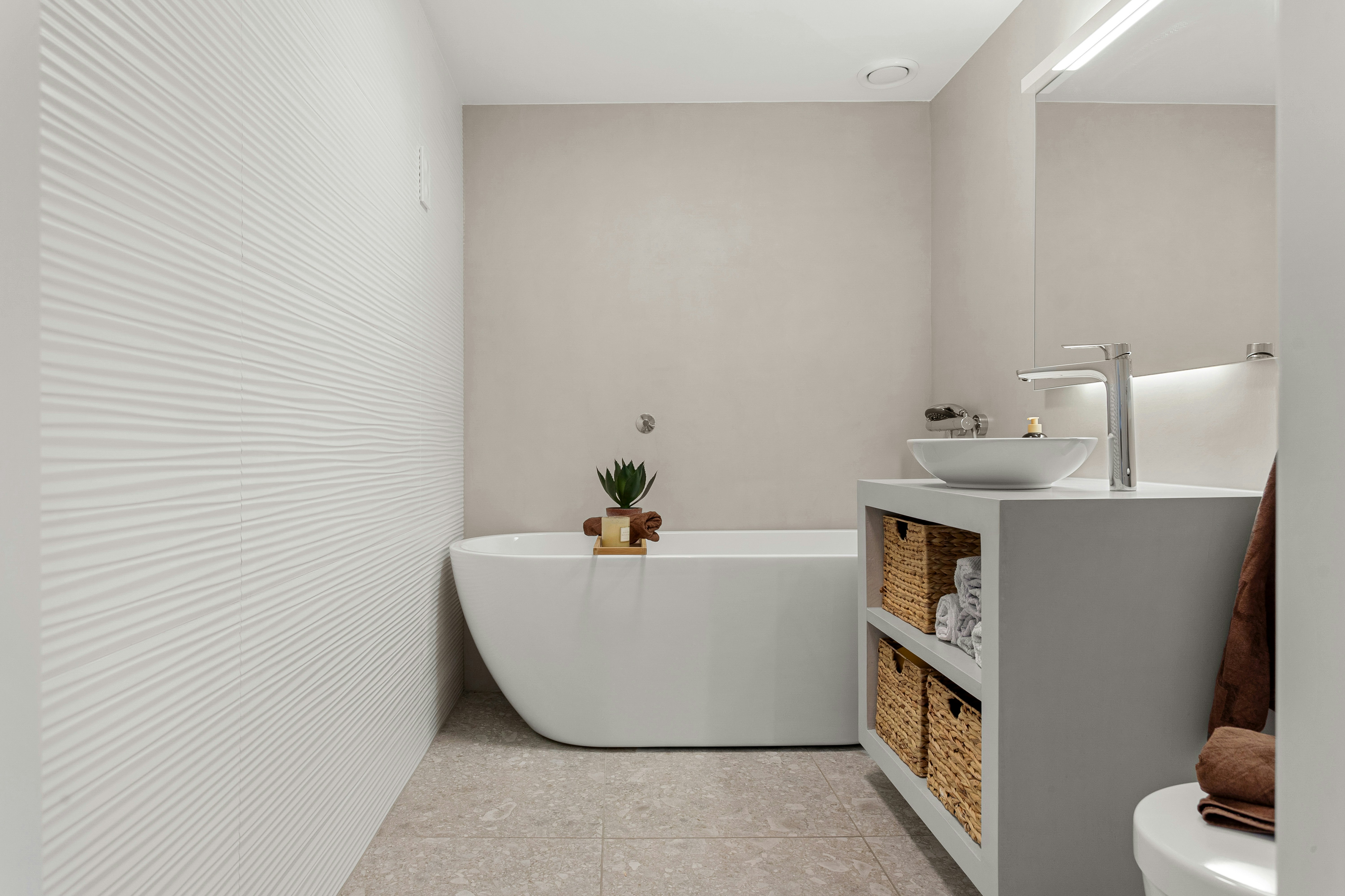 Clean, organized bathroom with sparkling fixtures